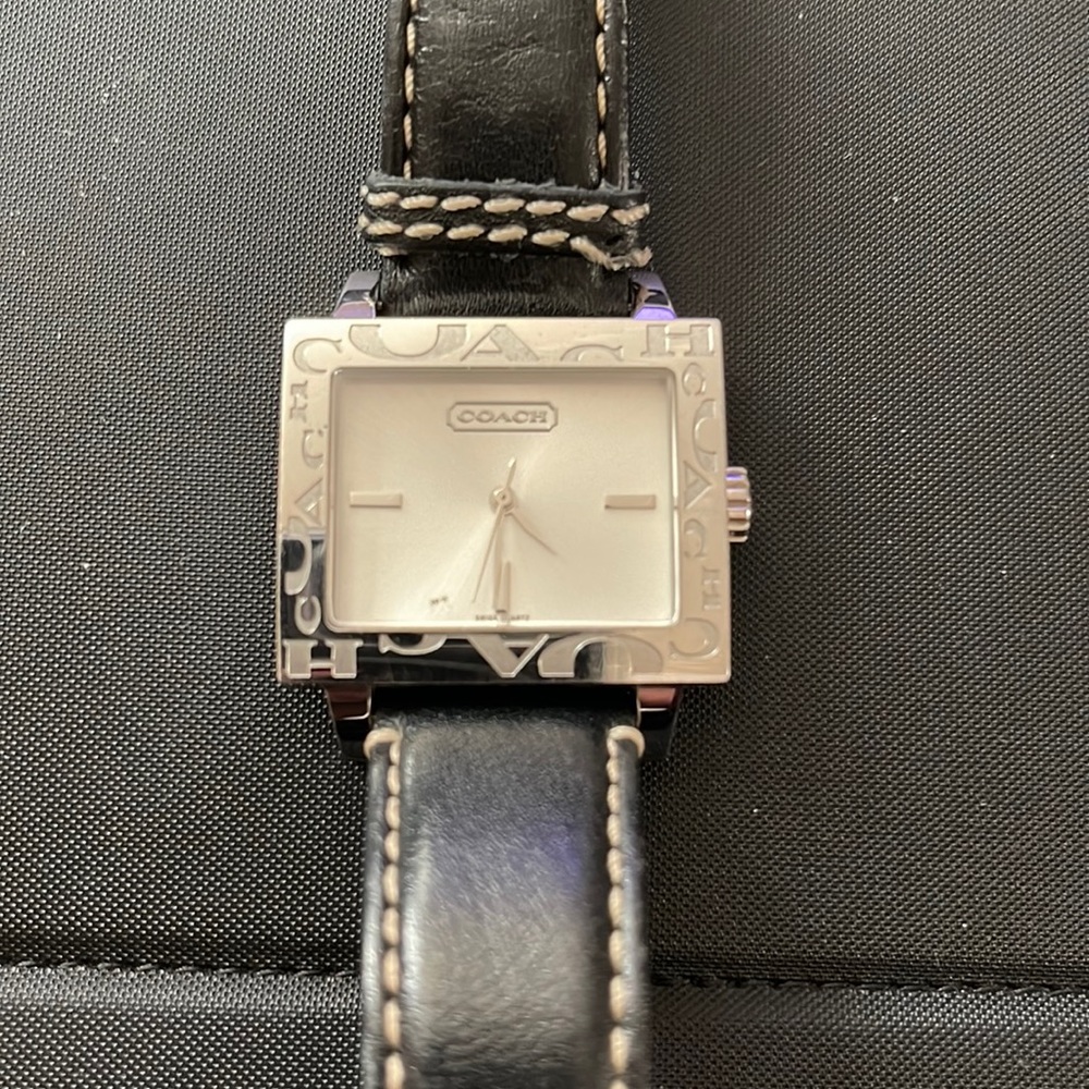 Coach watch with leather wrist strap.